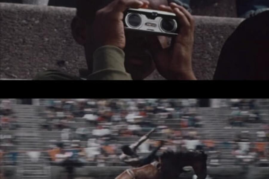 Still frame from Derrick Woods-Morrow's Untitled (Cowboy): good to me as I am to you film, showing a man watching rodeo through binoculars