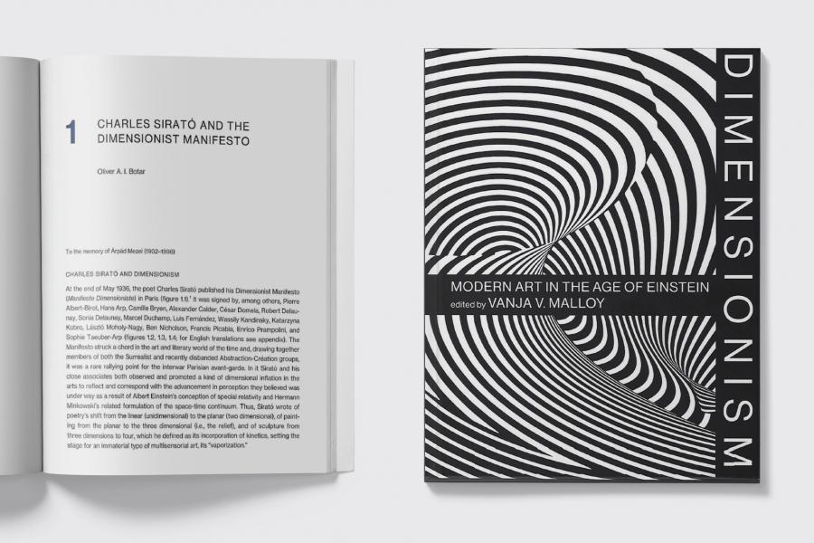 Book cover reading "The Dimensionist Manifesto" beside an open book with article text too small to read.