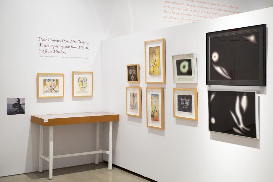 Bright geometric paintings hanged framed on a white gallery wall