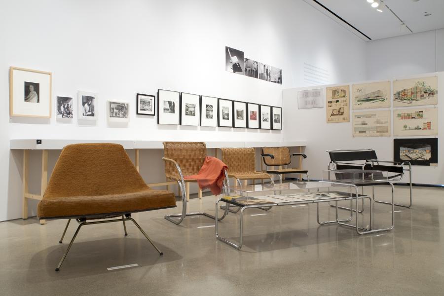 Mid century chairs sit grouped in the centre of the gallery 