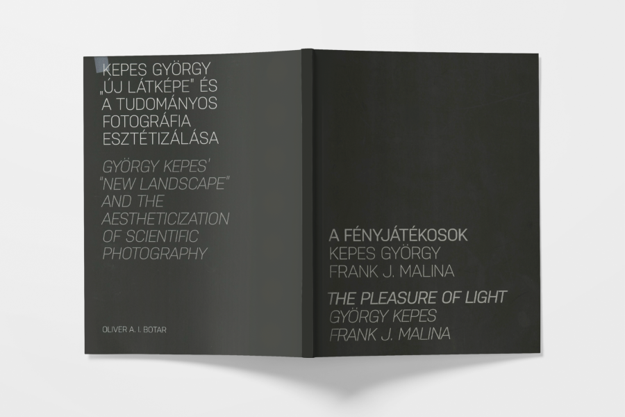 Book spread open laying flat with cover facing, reading "The Pleasure of Light, 2010".