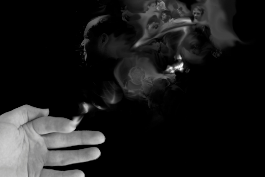 A black and white hand dissolves into plumbing smoke on a black background