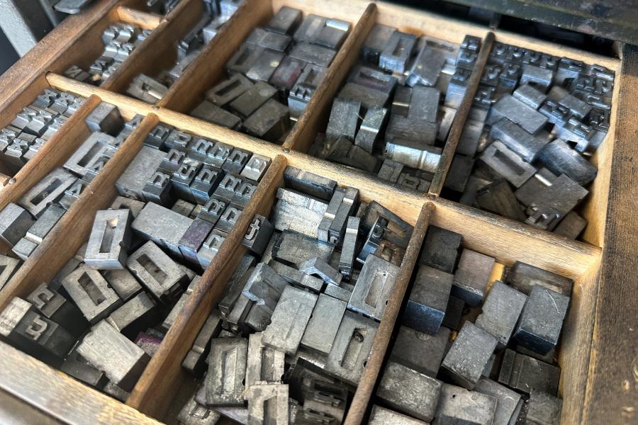 Open drawer with organized metal letterpress stamps