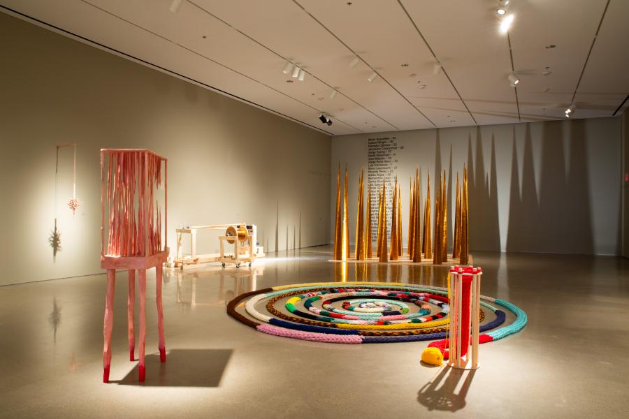 Gallery-wide view showcasing installations of mechanical and organic forms