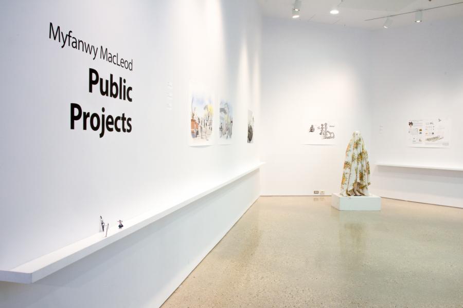 Exhibition entrance with "Myfanwy MacLeod: Public Projects" text on a white wall.