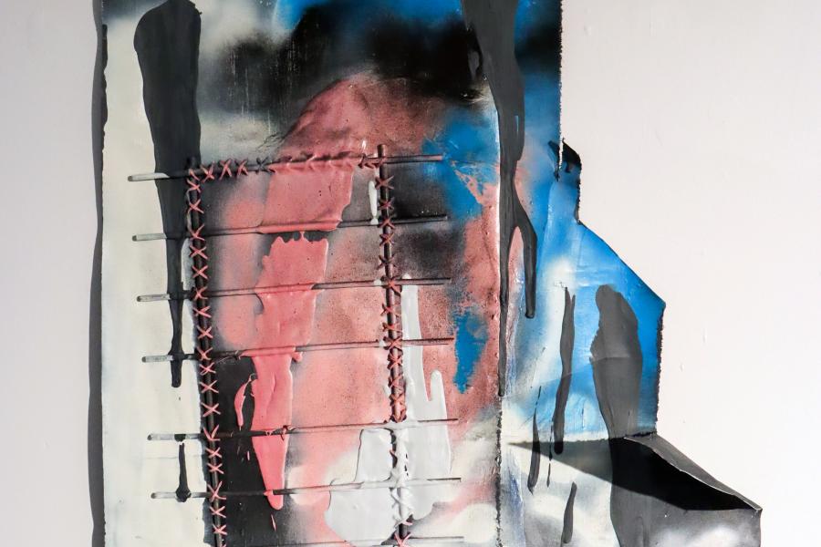 A mixed-media artwork featuring abstract shapes, stitched elements, and dripping paint in shades of pink, blue, black, and white on a textured surface.
