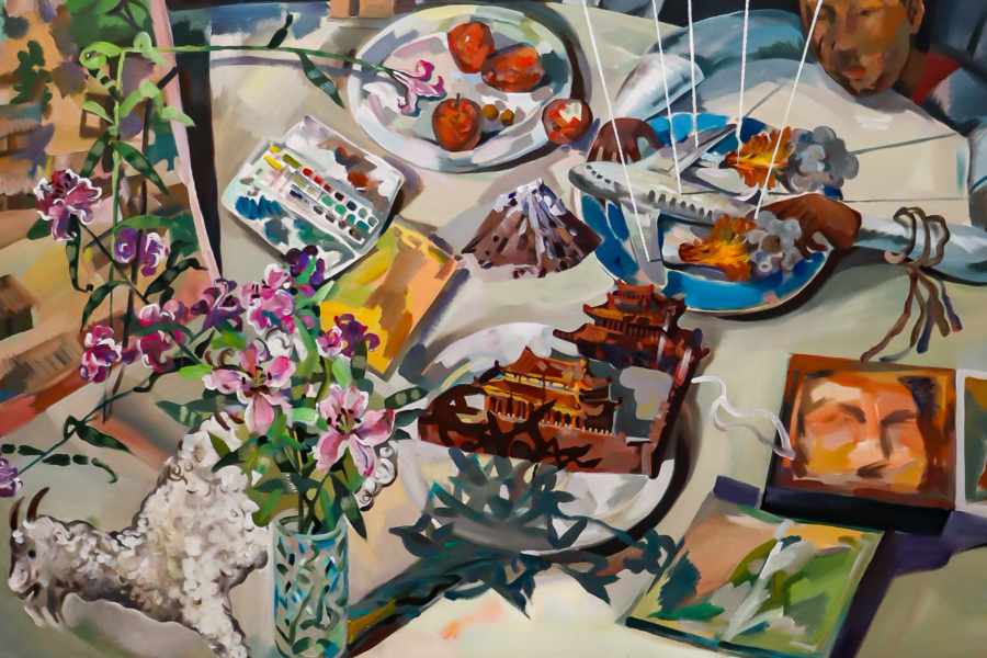  Xianghui Guan painting of a chaotic tabletop strewn with food, flowers, books, and model buildings, with a figure in the background appearing to manipulate a miniature war scene featuring airplanes and explosions.