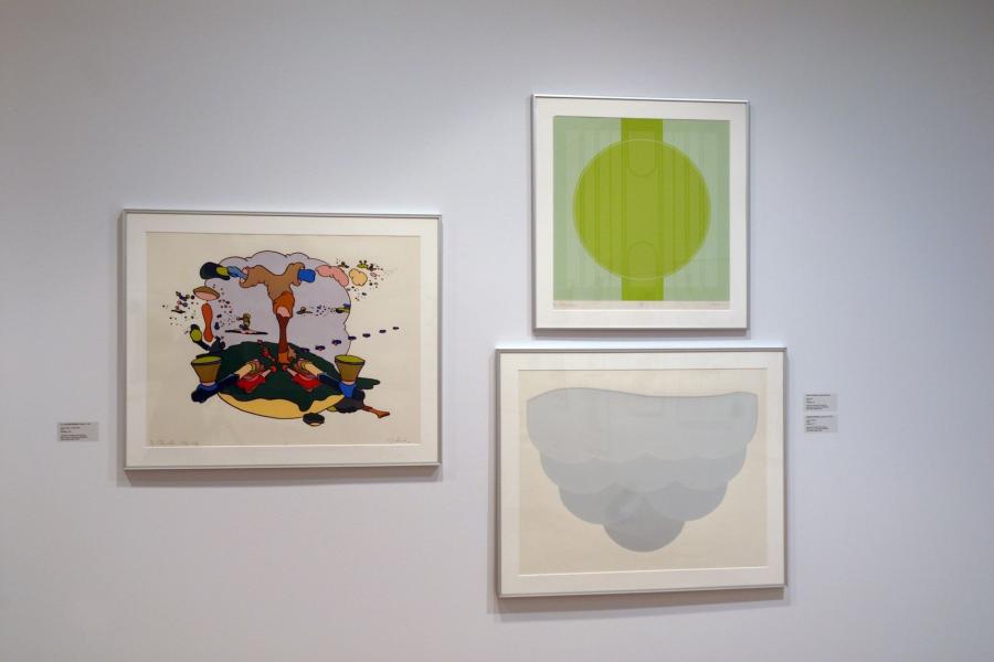 Three abstract prints. On the left is an arrangement of multicoloured forms on a beige background. On the upper right is a green circle and column on a green background, with faint vertical lines overlayed. On the bottom-right are rows of blue semi-circles growing lighter and wider towards the top, on a beige background.