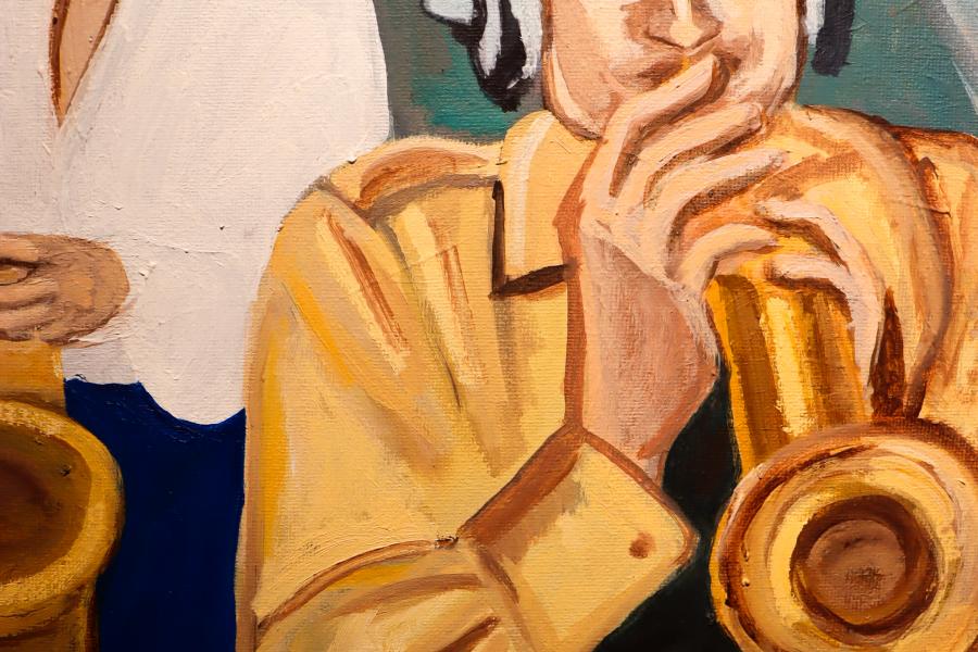 Close-up of a painted figure in warm yellow and brown tones, with a hand resting near the face.