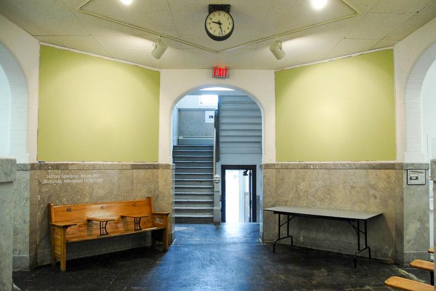 Wide view of the rotunda installation featuring two large green wall paintings and the projected title of Neues Bild (Rotunda, Winnipeg).