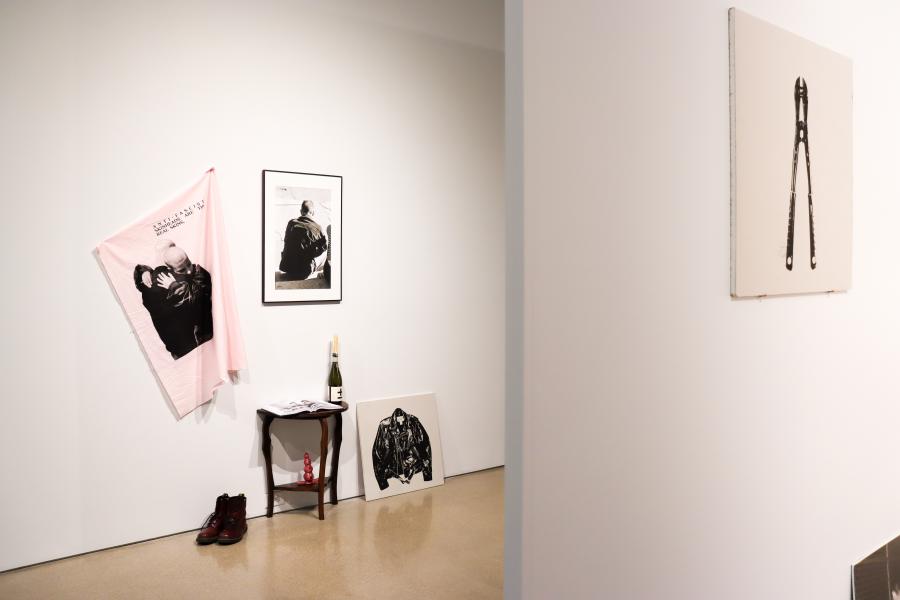 Installation view featuring textile, photography, prints, and sculptural objects in Punk Care Commons.