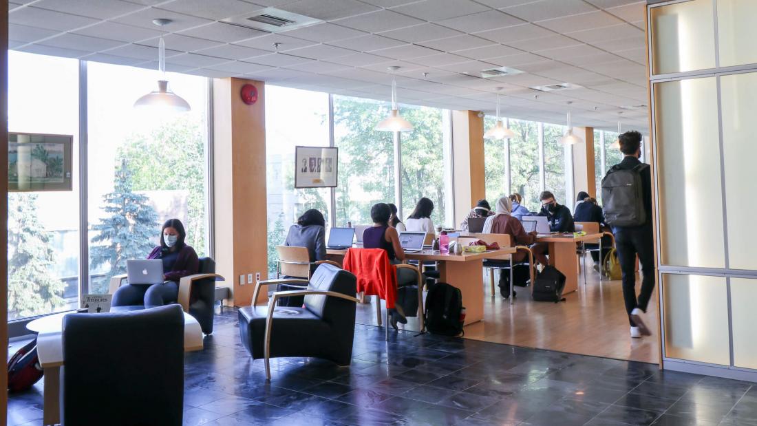 Interior photo of students studying quietly in the Icelandic Reading Room located on the third floor of the Elizabeth Dafoe Library.