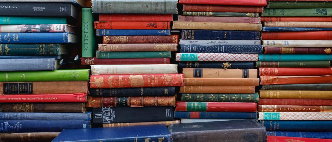 Stacks upon stacks of old hardcover books.