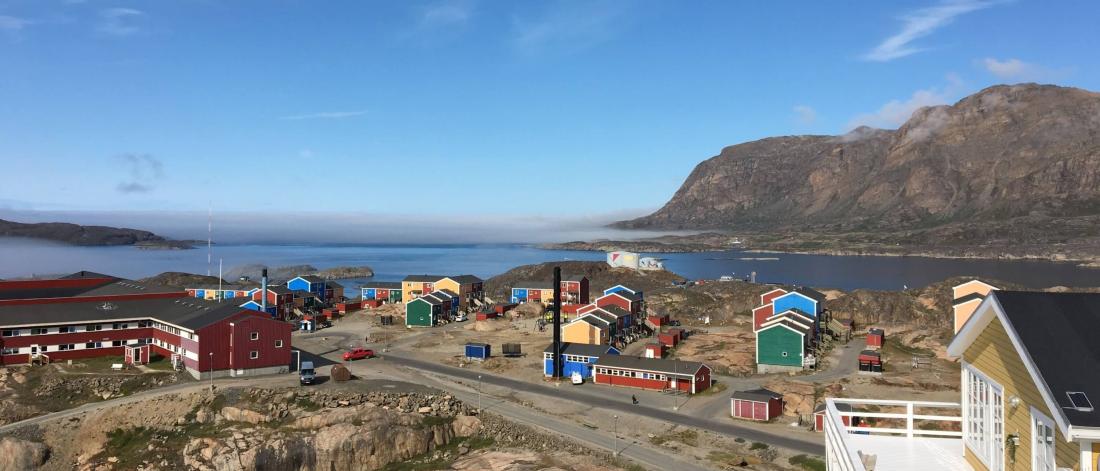 Colourful buildings against a blue sky and harbour at Sisimiut, Greenland.