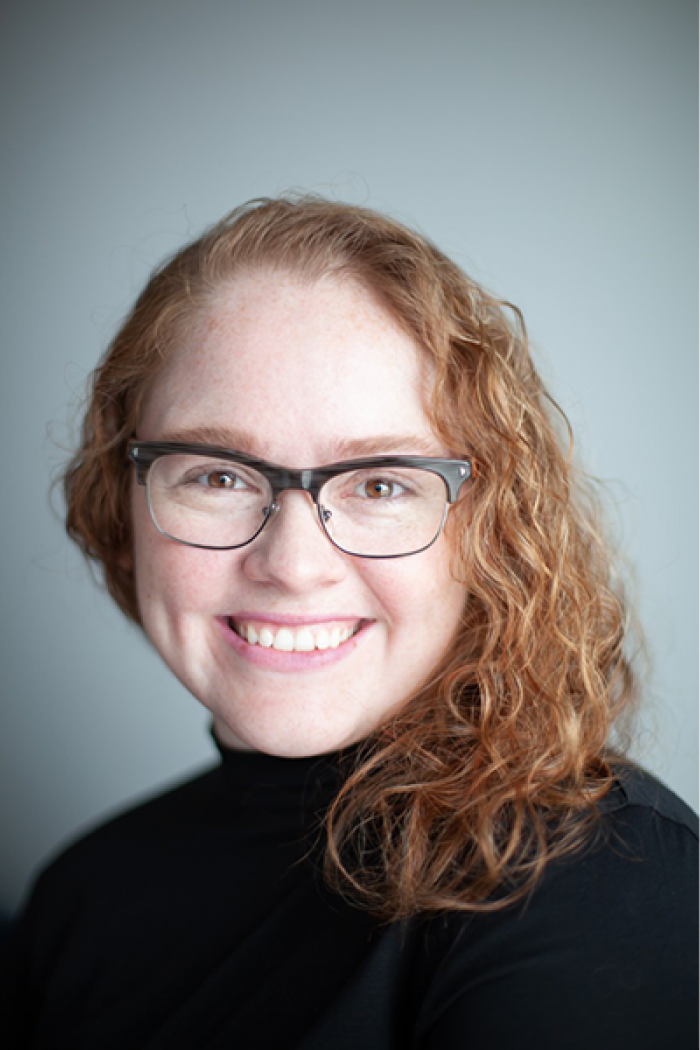 Merissa Daborn headshot in front of grey background.