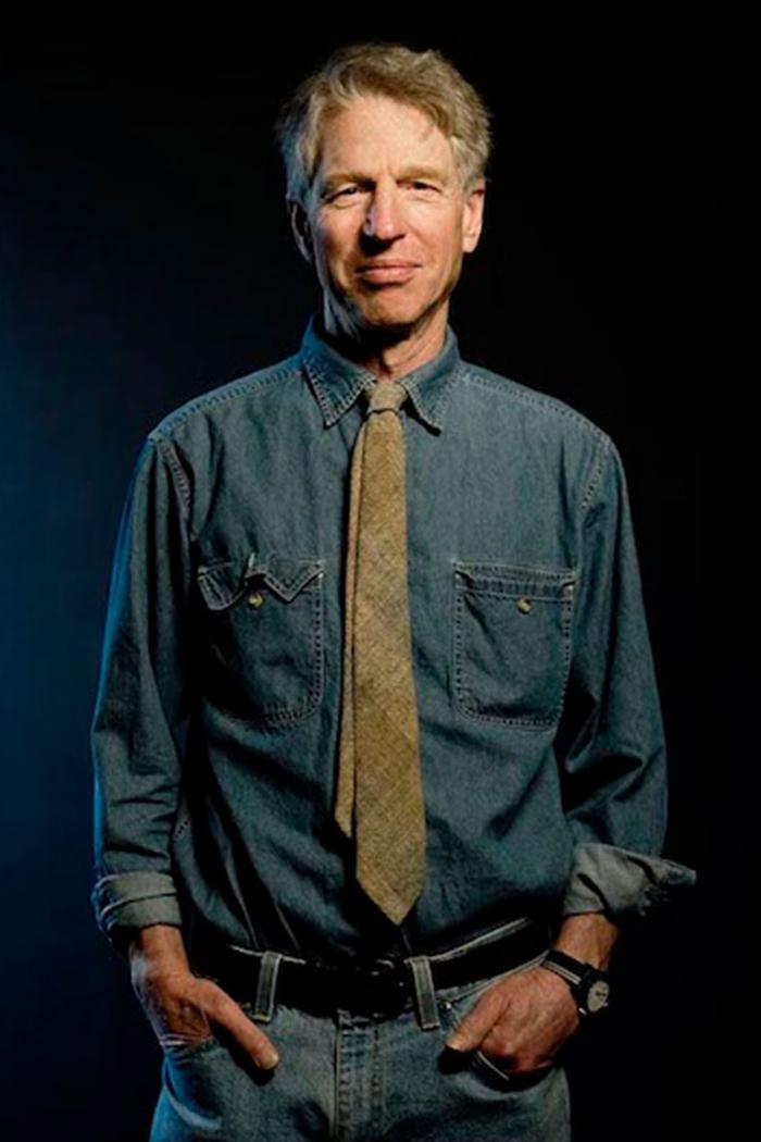 Headshot of Dr. Arthur Schafer in front of dark blue background.