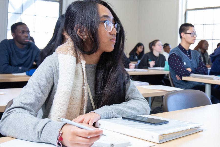 Students write notes during class.