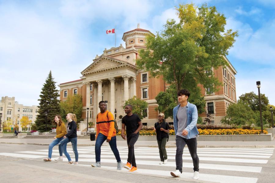 Students walking outdoors together at the University of Manitoba Fort Garry campus. 