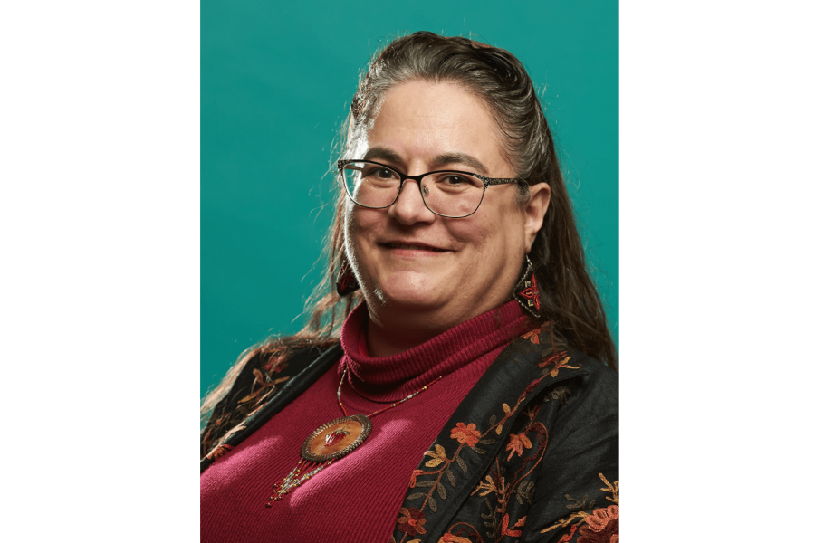 Headshot of Cary Miller with teal background.