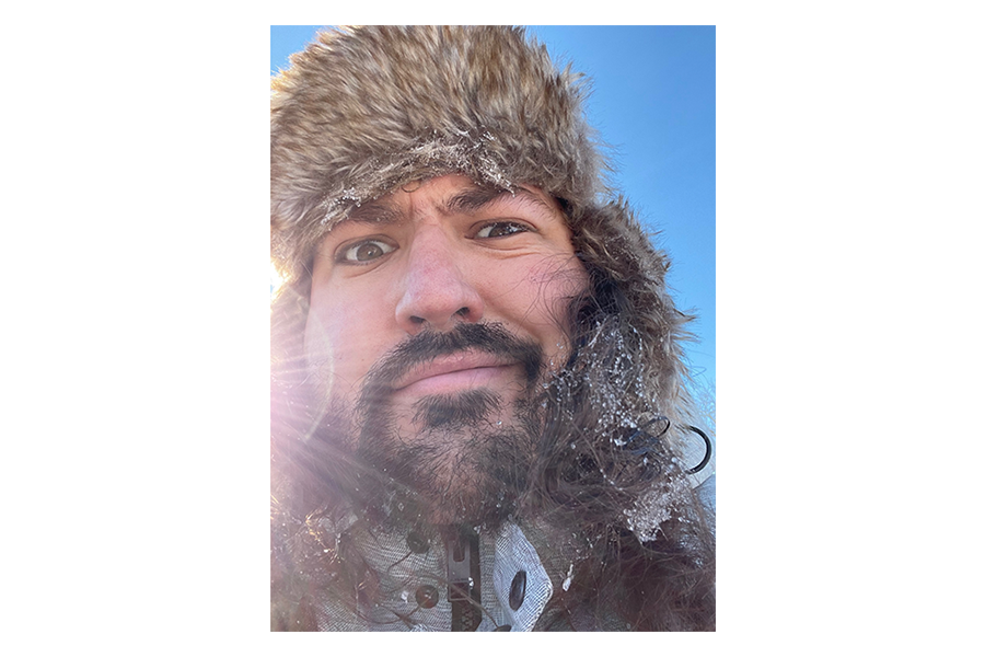 Headshot of David Parent looking into camera with fur hat on.