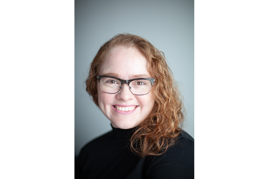 Merissa Daborn headshot in front of grey background.