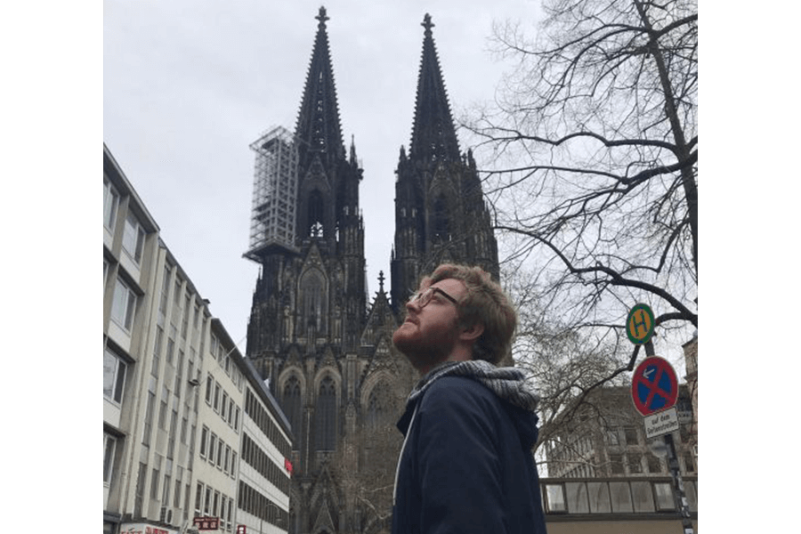 Student Timm Giessbrecht in Cologne, Germany with the Cologne Cathedral in the background.