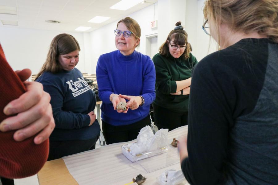 Lea Stirling shows students artifacts in a Classics lab.