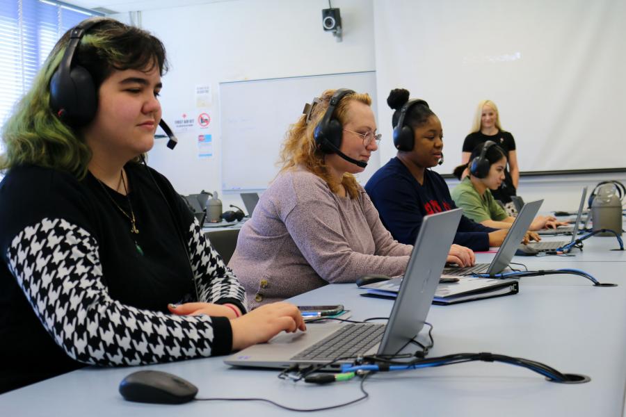 Students wearing headsets use a computer lab at the Faculty of Arts Language Centre.