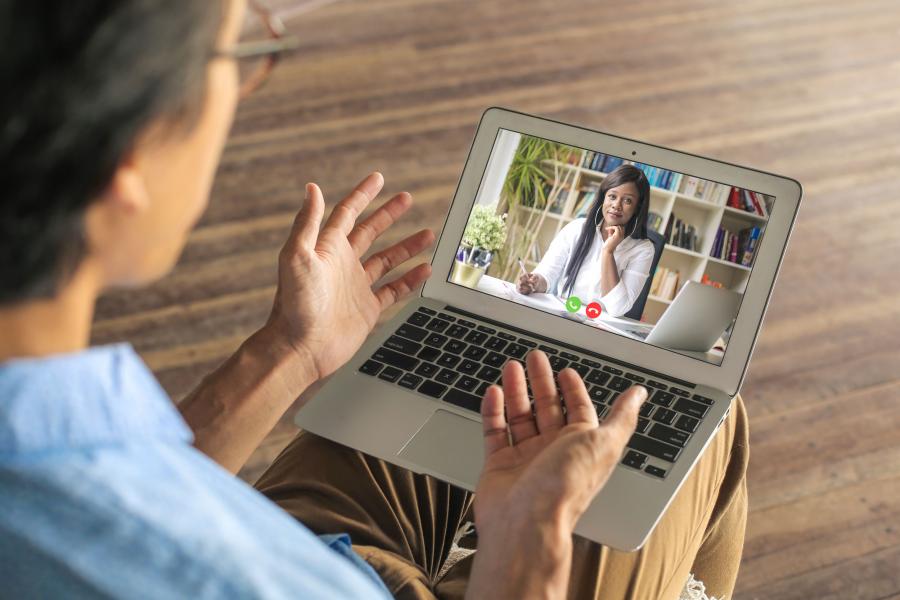 Man and woman having a video conversation through a laptop.
