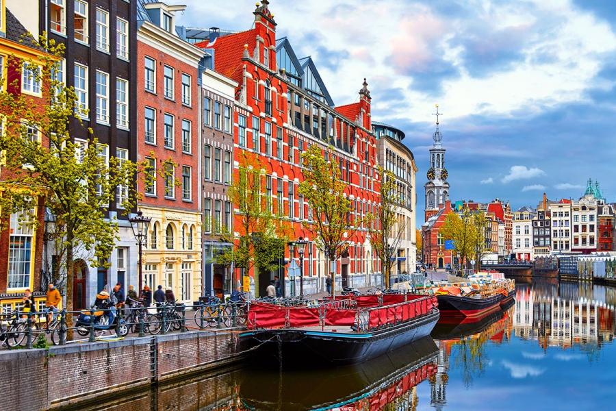 Colourful European streetscape along a river.