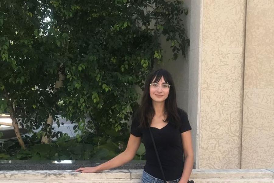 Kyla Wiens standing in front of limestone building.