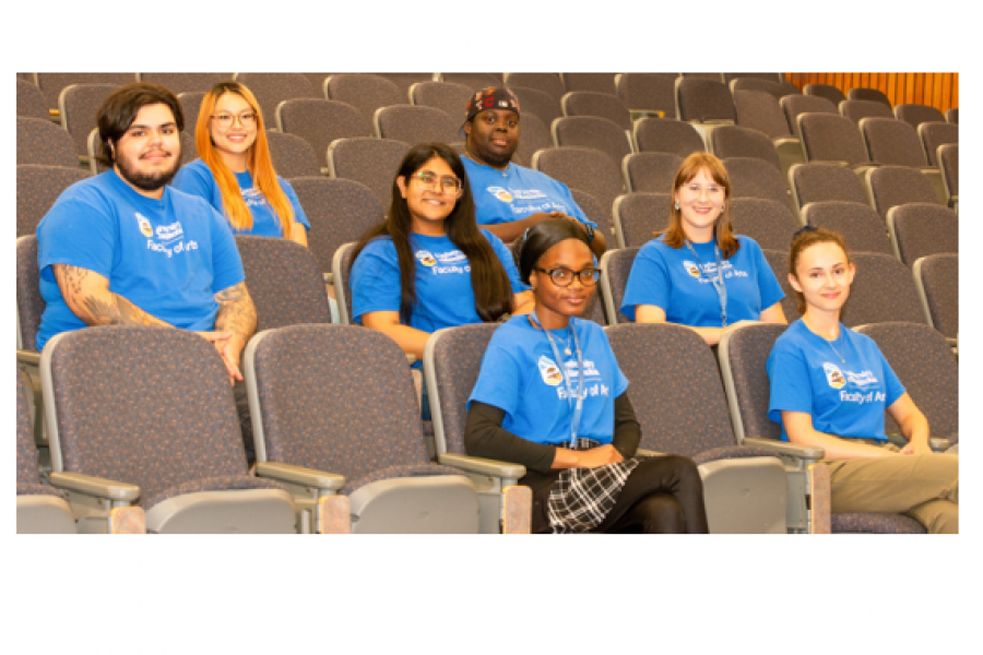 Group of students all wearing the same blue t-shirt. 