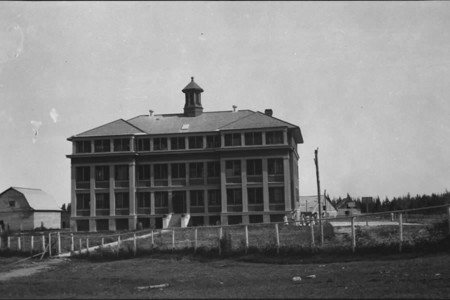 Old school building in a black and white photo.