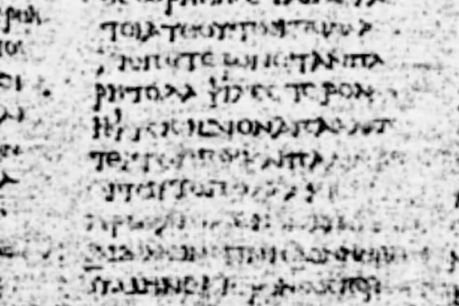 Digitized capture of ancient scrolls with lines of text that are faded on a page.