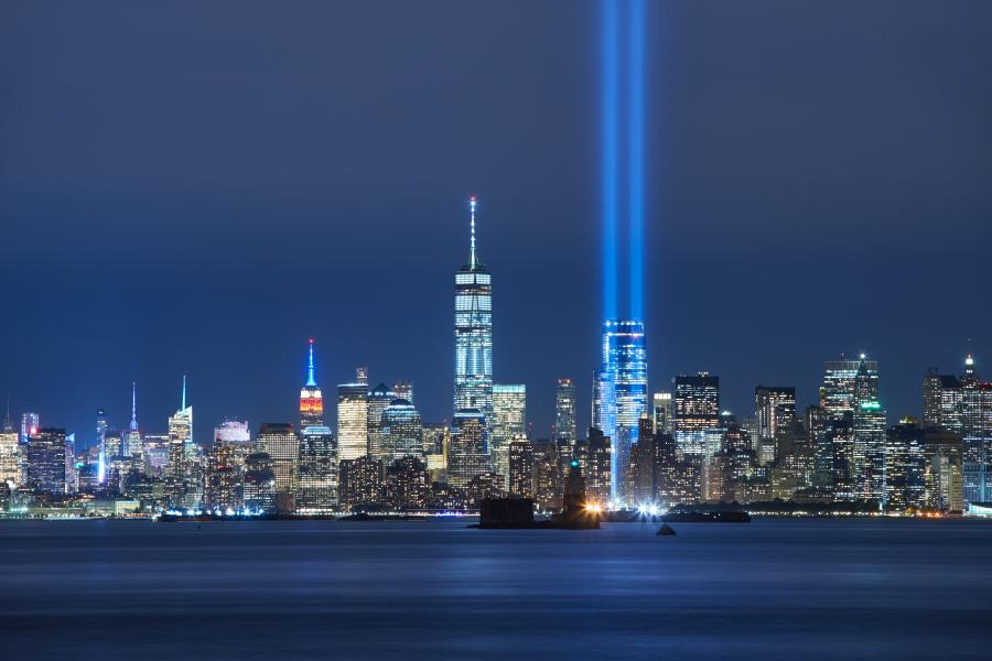 Skyline of New York City at night showing the two beams of light tribute to the twin towers.