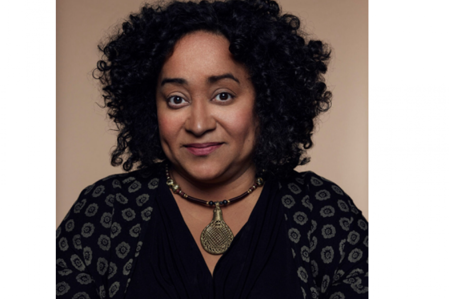 Black presenting female smiling at the camera in a headshot photo. 