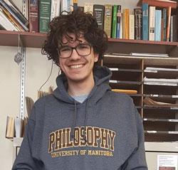 Centre for Professional and Applied Ethics Fellow Dimitar Tomovski wearing a University of Manitoba Philosophy sweater.
