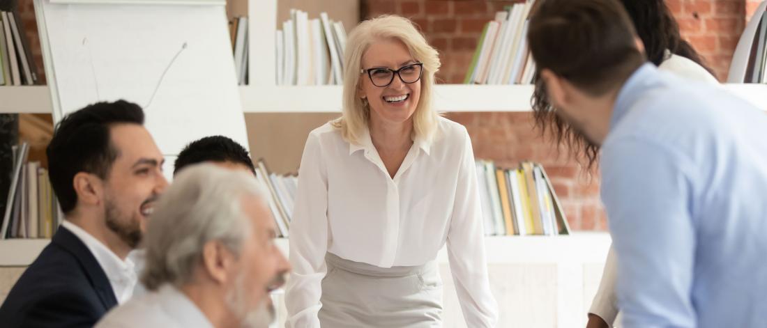 Smiling business executive leading meeting.