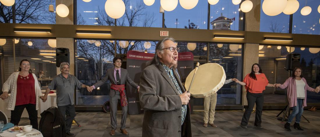 Carl Stone drumming at Indigenous Business Education Partners grad.