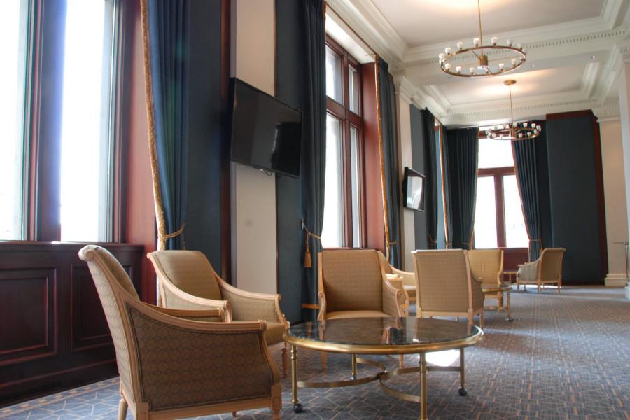 The Learning Commons Reception area with tall ceilings, windows and multiple seating areas.