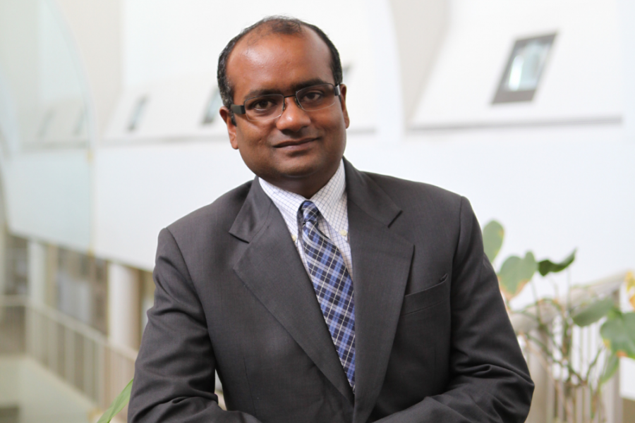 Professor Gajpal's professional shoot. He is wearing a dark grey suit with blue tie