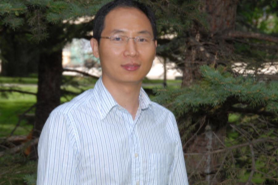 Department Head Jijun Gao wearing a white shirt with thin, blue stripes