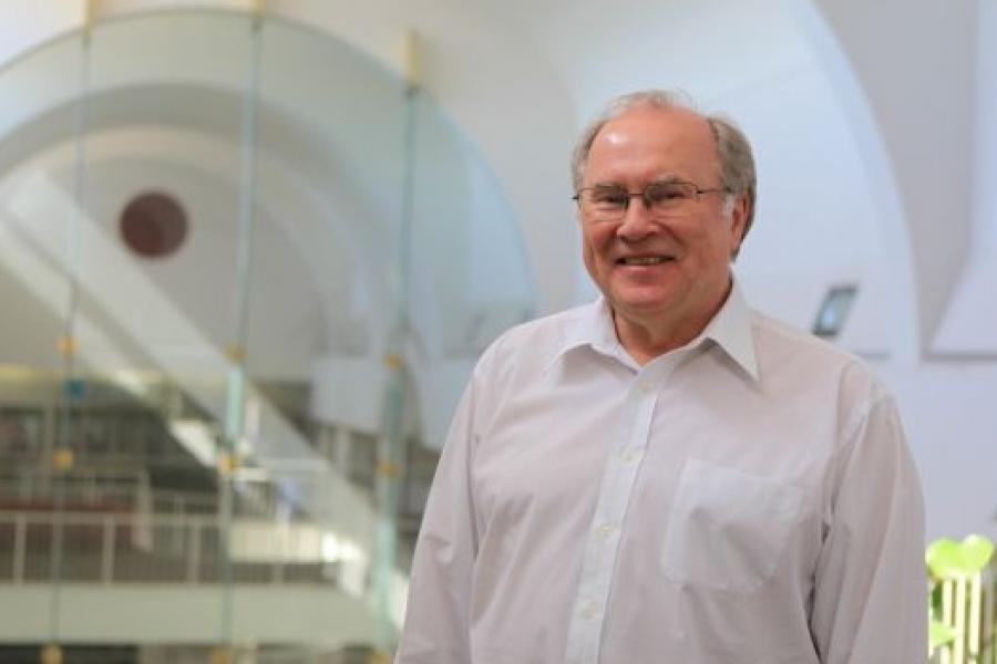 Ron McLachlin wears a white shirt. The shot is on 3rd floor of Asper building