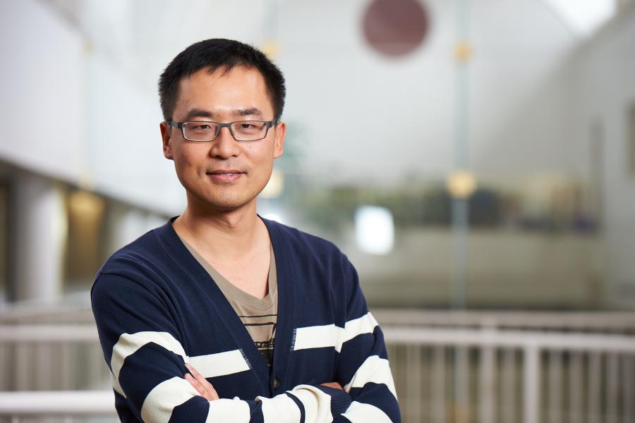 Associate Professor Samuel Hao's professional shoot. He is wearing a blue & white stripes cardigan.