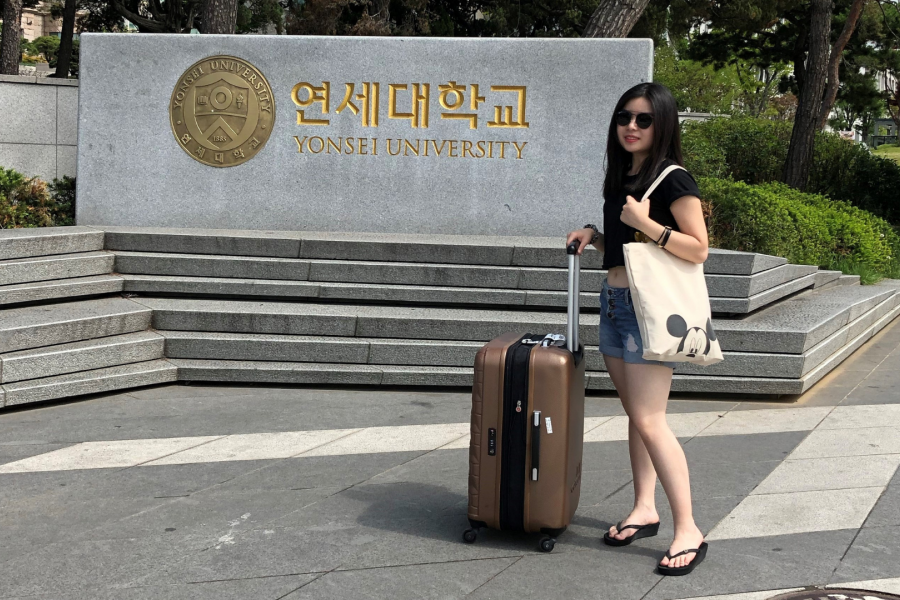 photo of a female student posing next to a Korea university sign