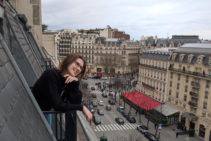 photo of a female student leaning on a balcony in France