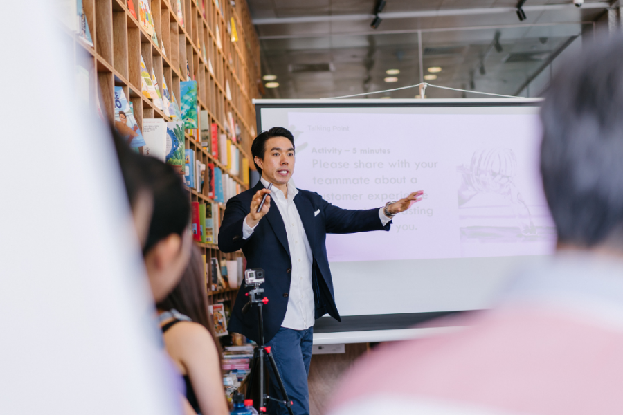 photo of a guy speaking in front of a crowd