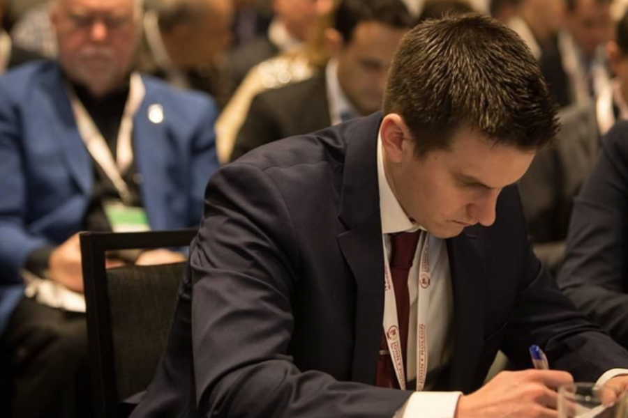 a focused male student reading and analyzing a business case
