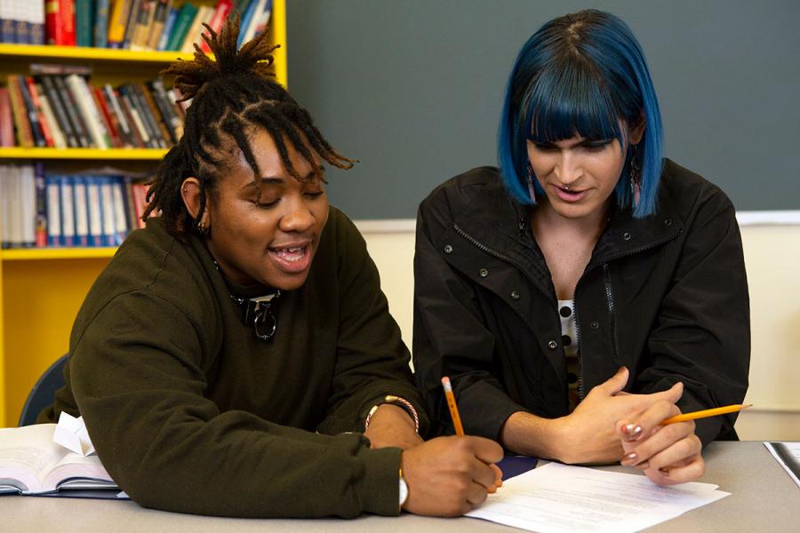 Two-non-binary-students-doing-work-together-in-class