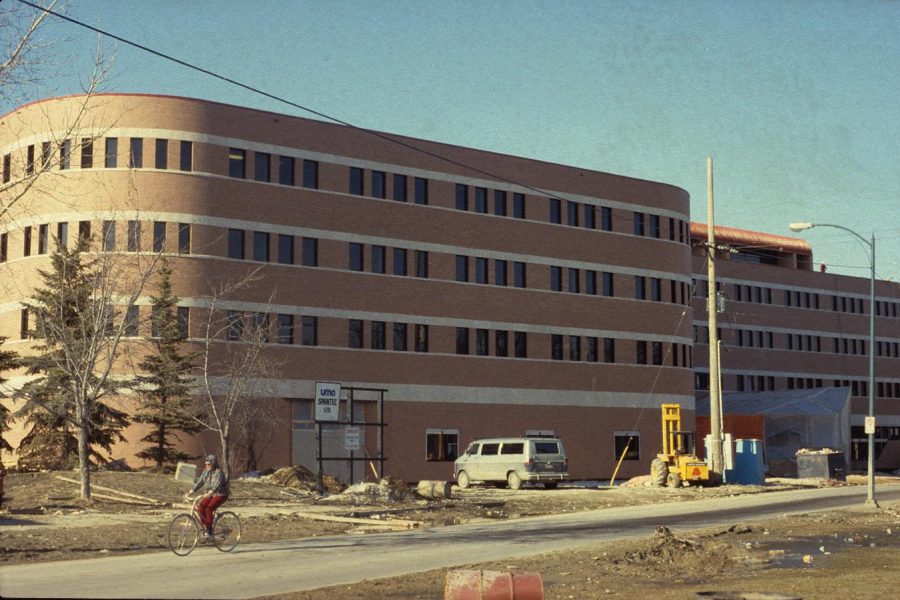 A grainy colour photo of the Drake Building being constructed in the 1980's. It appears to be srping.